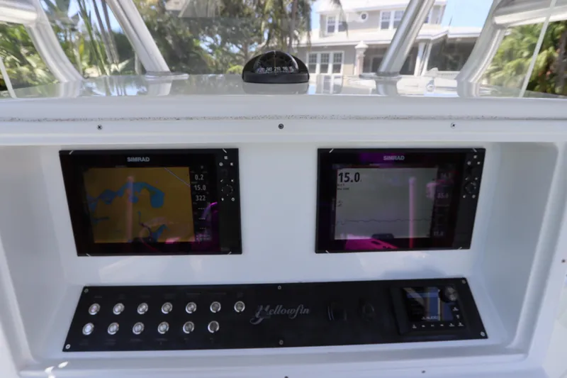  Yacht Photos Pics 2013 Yellowfin 32 Offshore boat dashboard with dual Simrad displays and control panel.