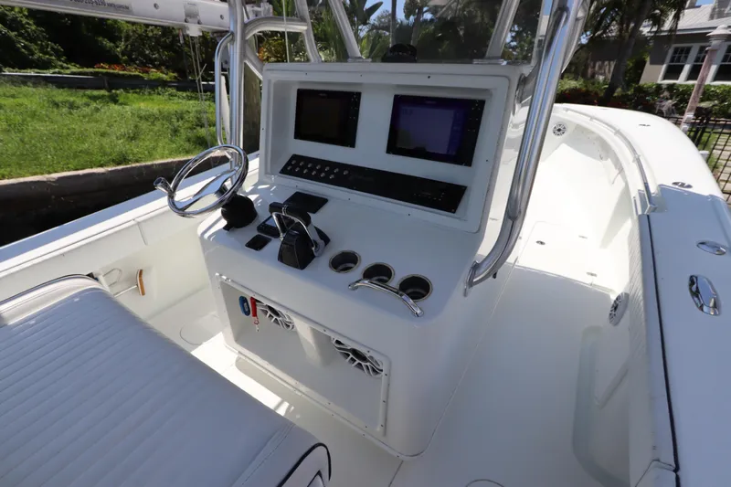  Yacht Photos Pics 2013 Yellowfin 32 Offshore boat cockpit with steering wheel and control panel.