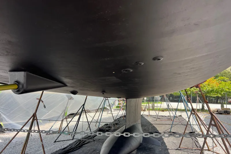  Yacht Photos Pics Underside view of 2023 Jeanneau 65 yacht hull in dry dock.