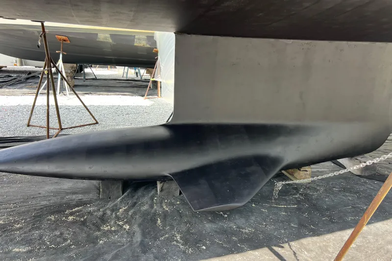  Yacht Photos Pics 2023 Jeanneau 65 yacht keel in dry dock, supported by stands.