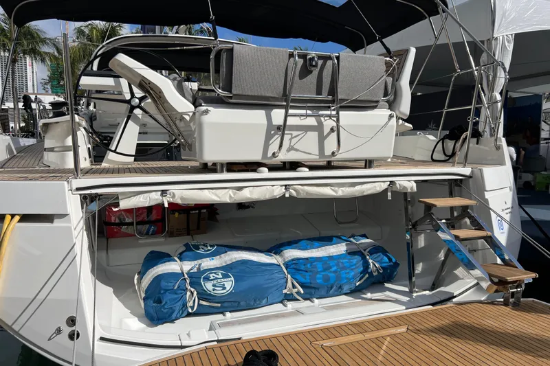  Yacht Photos Pics 2023 Jeanneau 65 yacht with open storage compartment and deck seating.