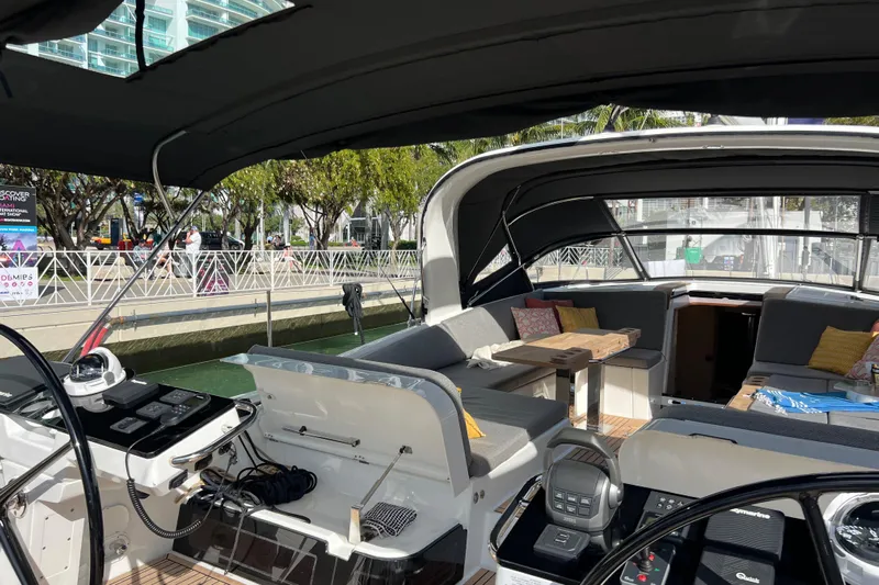  Yacht Photos Pics 2023 Jeanneau 65 yacht interior with modern seating and navigation controls.