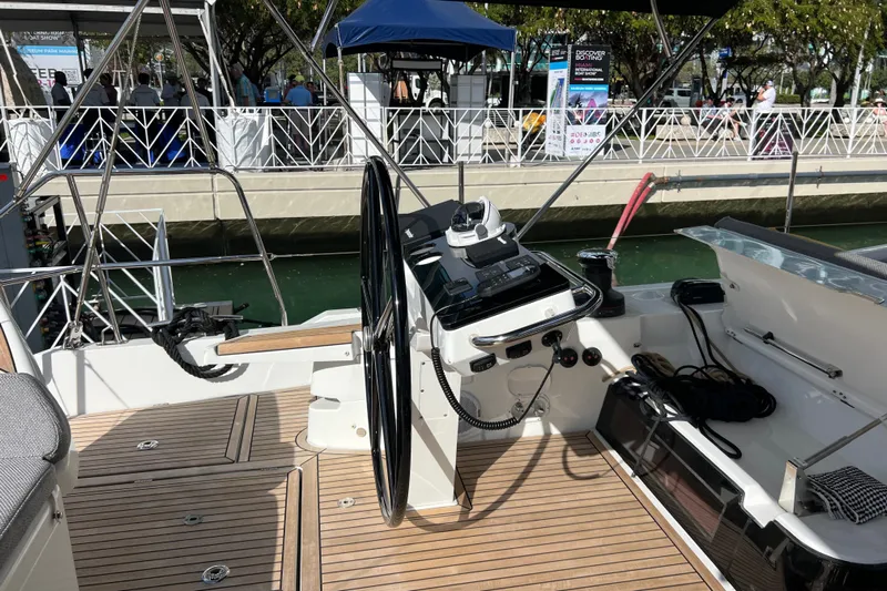  Yacht Photos Pics 2023 Jeanneau 65 yacht cockpit with steering wheel and navigation controls.