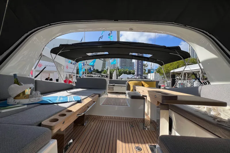  Yacht Photos Pics Luxurious interior of 2023 Jeanneau 65 yacht with elegant seating and wooden accents.