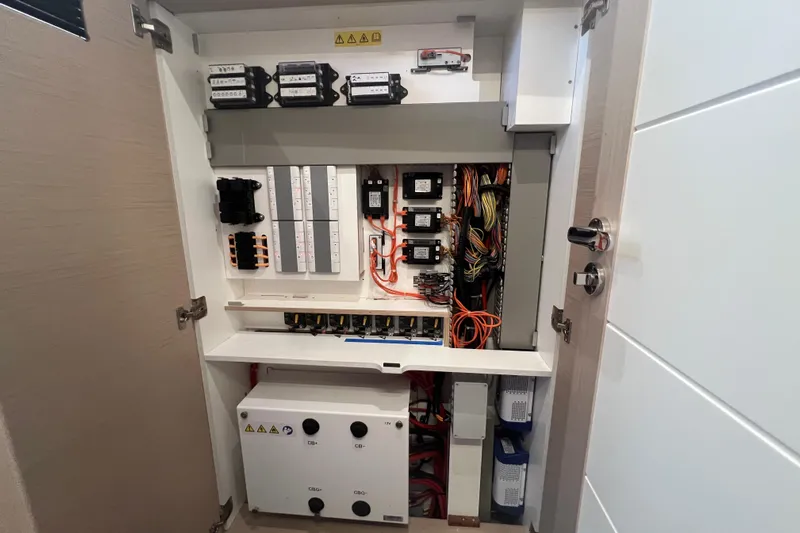 Yacht Photos Pics Electrical panel inside 2023 Jeanneau 65 yacht, showcasing wiring and circuit components.