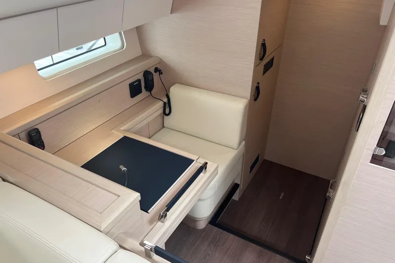  Yacht Photos Pics Luxurious interior of 2023 Jeanneau 65 yacht with modern seating and navigation equipment.