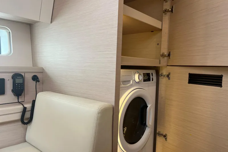  Yacht Photos Pics Interior of 2023 Jeanneau 65 yacht with washing machine and communication equipment.