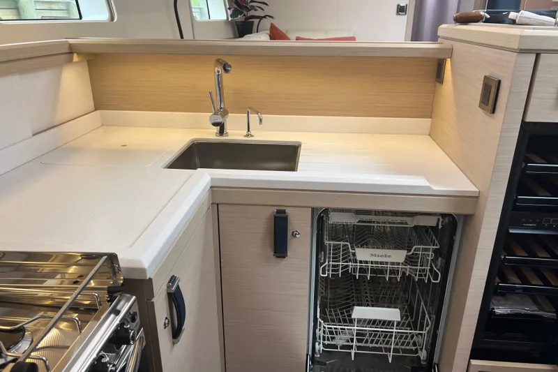 Yacht Photos Pics Modern kitchen in 2023 Jeanneau 65 yacht with sink and Miele dishwasher.