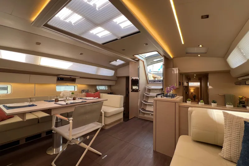  Yacht Photos Pics Luxurious interior of 2023 Jeanneau 65 yacht with elegant dining area and modern design.