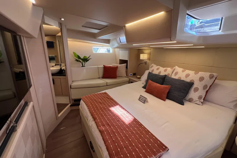  Yacht Photos Pics Luxurious interior of 2023 Jeanneau 65 yacht with elegant bedroom and modern decor.