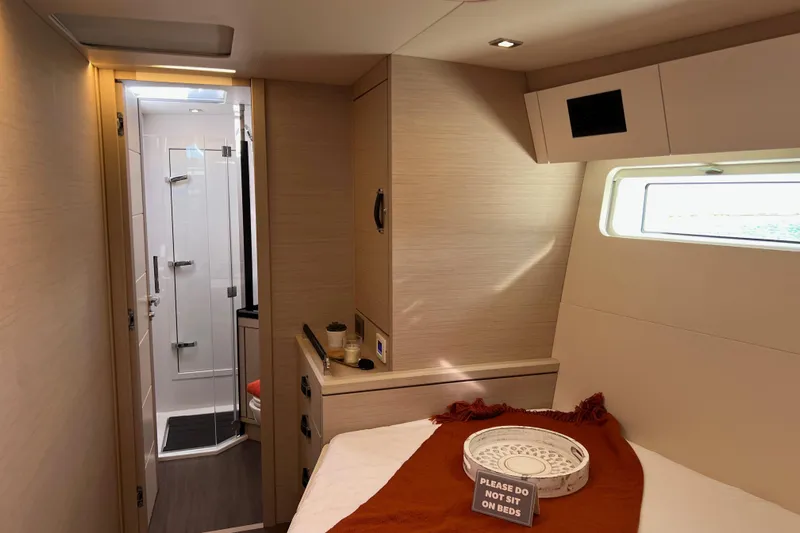  Yacht Photos Pics Luxurious interior of 2023 Jeanneau 65 yacht cabin with modern bathroom.