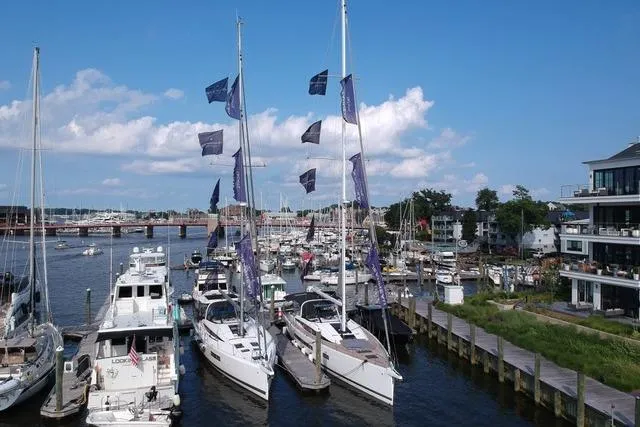  Yacht Photos Pics Marina with Jeanneau 65 yachts, 2023 model, docked under a clear blue sky.