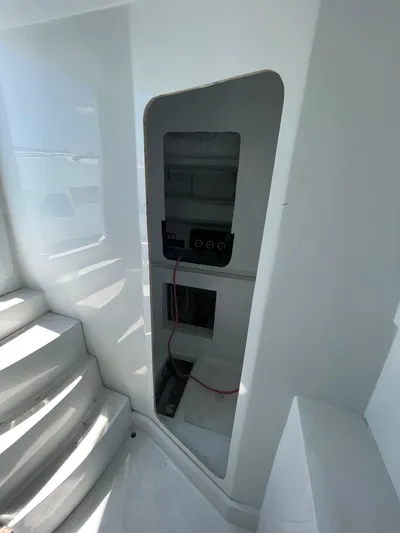  Yacht Photos Pics Interior view of a 2026 Streamline 45 boat, featuring a control panel and steps.