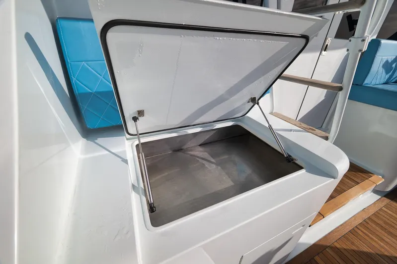  Yacht Photos Pics Open storage compartment on 1997 Garlington 61 boat with blue seating.