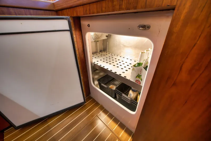  Yacht Photos Pics Open refrigerator in 1997 Garlington 61 yacht, showcasing organized interior storage.