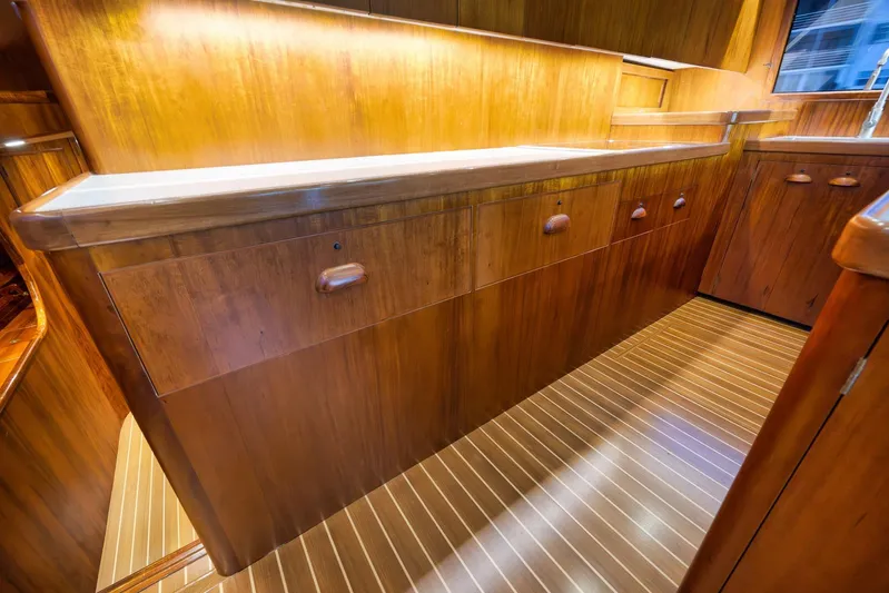  Yacht Photos Pics Luxurious wooden interior of a 1997 Garlington 61 yacht, featuring elegant cabinetry and flooring.