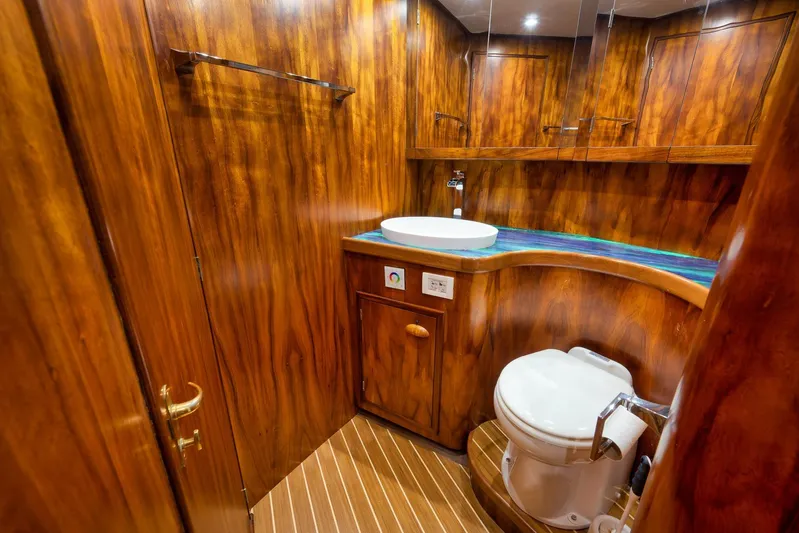  Yacht Photos Pics Luxurious wooden bathroom interior in a 1997 Garlington 61 yacht, featuring modern fixtures.