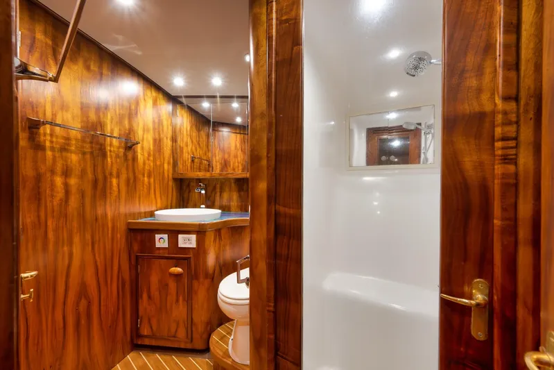  Yacht Photos Pics Luxurious wooden bathroom interior on a 1997 Garlington 61 yacht, featuring modern fixtures.