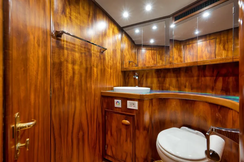  Yacht Photos Pics Luxurious wooden bathroom interior in 1997 Garlington 61 yacht, featuring sink and toilet.