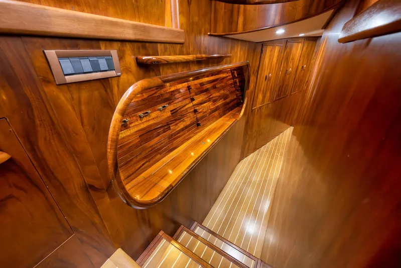  Yacht Photos Pics Luxurious wooden interior of a 1997 Garlington 61 yacht, featuring elegant cabinetry and lighting.
