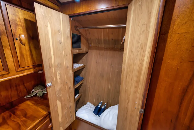  Yacht Photos Pics Wooden closet interior on a 1997 Garlington 61 yacht, featuring shelves and hanging space.