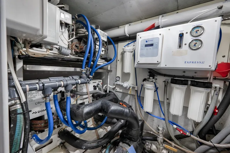  Yacht Photos Pics Engine room of a 1997 Garlington 61 yacht with complex piping and filtration systems.