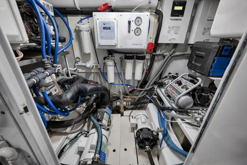  Yacht Photos Pics Engine room of a 1997 Garlington 61 boat, featuring complex machinery and piping.