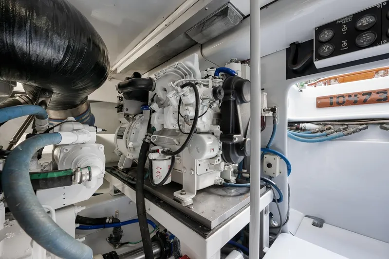  Yacht Photos Pics Engine room of a 1997 Garlington 61 boat, featuring complex machinery and piping.