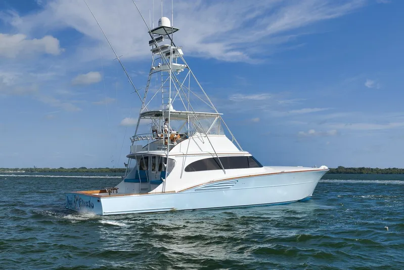  Yacht Photos Pics 1997 Garlington 61 yacht cruising on open water under a clear blue sky.