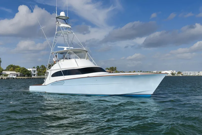  Yacht Photos Pics 1997 Garlington 61 yacht on calm waters under a partly cloudy sky.
