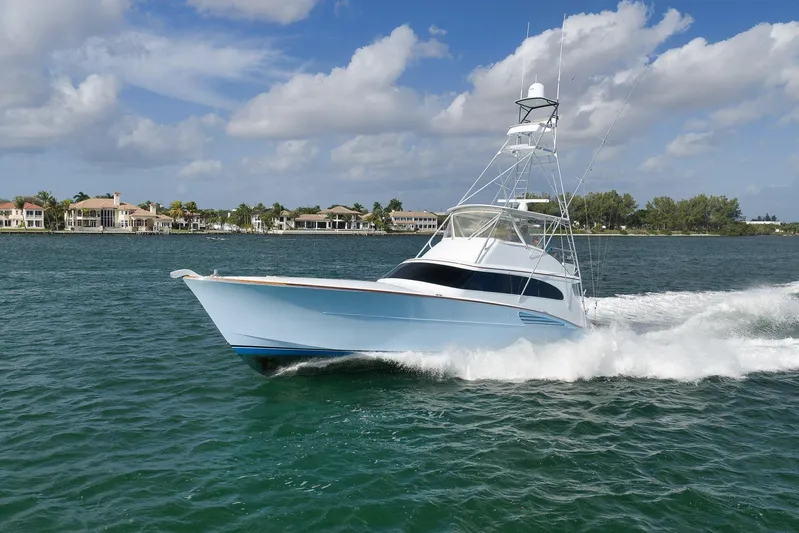  Yacht Photos Pics 1997 Garlington 61 yacht cruising on a sunny day near luxury waterfront homes.