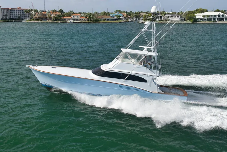  Yacht Photos Pics 1997 Garlington 61 yacht cruising on water near coastal homes.