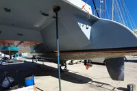 Catamaran NIMBLE 50, 2001 model, under maintenance on dry dock, with visible hull and support structures.