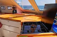 Interior of 2001 Catamaran NIMBLE 50 kitchen with stove, cabinets, and ocean view.