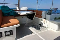 2001 Catamaran NIMBLE 50 cockpit with seating, table, and ocean view.