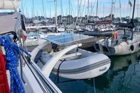 Catamaran NIMBLE 50, 2001 model, docked in a marina with inflatable dinghy and colorful ropes.