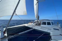 Catamaran NIMBLE 50 sailing on open sea under clear blue sky, 2001 model.