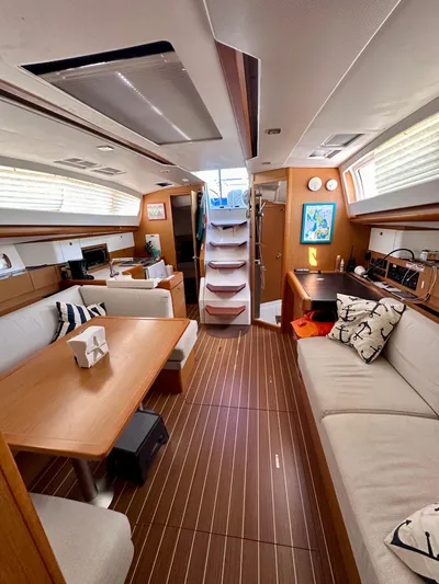 Volare Yacht Photos Pics Interior of 2014 Jeanneau Sun Odyssey 44 DS yacht with modern furnishings and wood flooring.