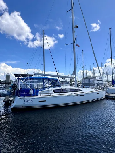 Volare Yacht Photos Pics 2014 Jeanneau Sun Odyssey 44 DS sailboat docked in marina under blue sky.