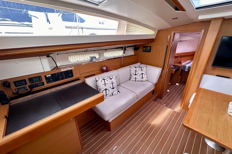 Volare Yacht Photos Pics Interior of 2014 Jeanneau Sun Odyssey 44 DS yacht with modern furnishings and navigation equipment.