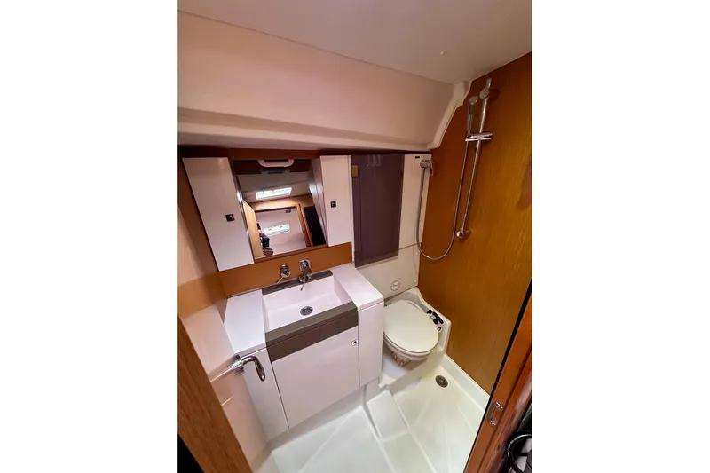 Volare Yacht Photos Pics Bathroom interior of 2014 Jeanneau Sun Odyssey 44 DS yacht, featuring sink, toilet, and shower.