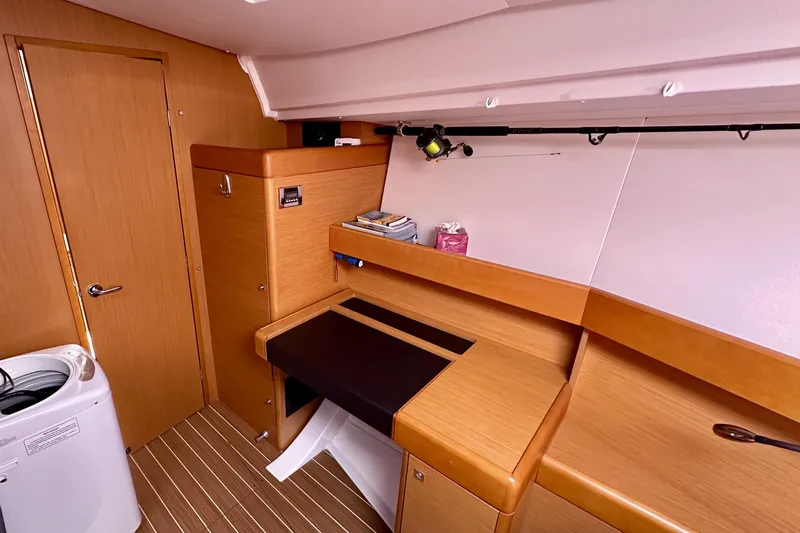 Volare Yacht Photos Pics 2014 Jeanneau Sun Odyssey 44 DS interior with wooden cabinetry and compact workspace.