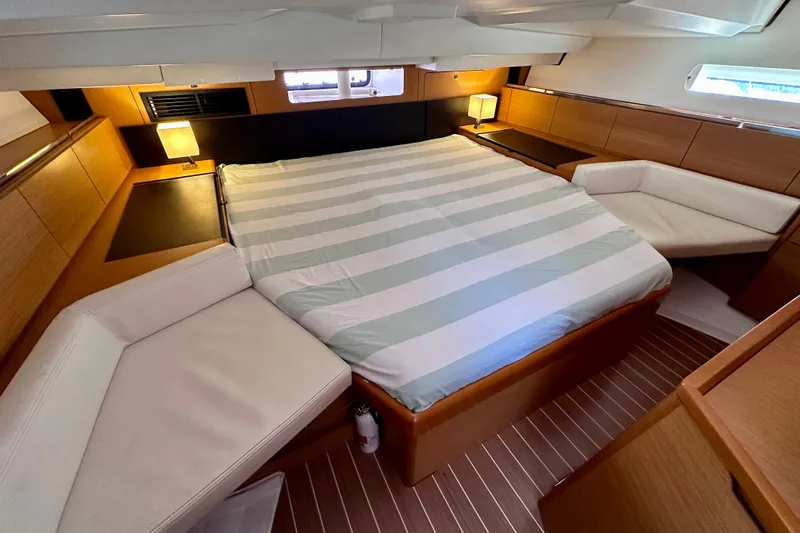 Volare Yacht Photos Pics Luxurious cabin interior of 2014 Jeanneau Sun Odyssey 44 DS yacht with cozy bed and seating.