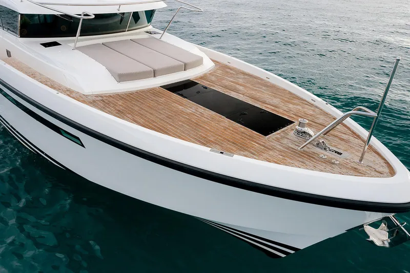 Freya Yacht Photos Pics 2023 Delta Powerboats 54 IPS yacht with sleek design and spacious deck on calm waters.