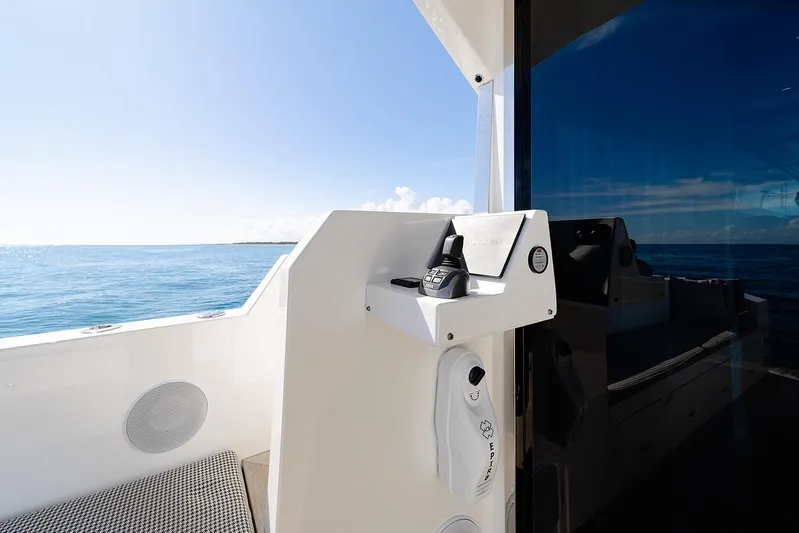 Freya Yacht Photos Pics 2023 Delta Powerboats 54 IPS yacht, ocean view, sleek design, modern controls, sunny day.