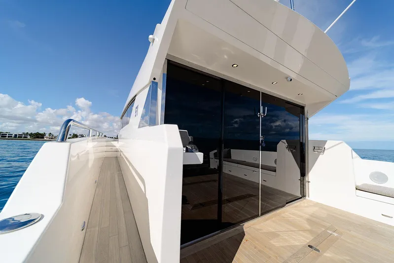 Freya Yacht Photos Pics 2023 Delta Powerboats 54 IPS yacht with sleek design and glass doors on open sea.