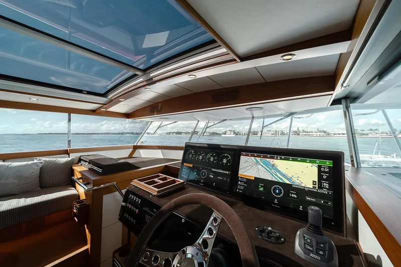 Freya Yacht Photos Pics Interior view of 2023 Delta Powerboats 54 IPS, featuring modern navigation controls and panoramic windows.