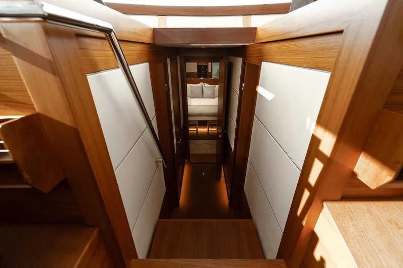Freya Yacht Photos Pics Luxurious interior of 2023 Delta Powerboats 54 IPS, featuring elegant wood and white paneling.