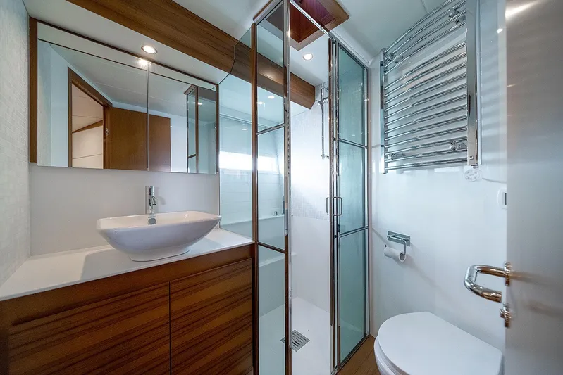 Freya Yacht Photos Pics Luxurious bathroom in 2023 Delta Powerboats 54 IPS, featuring modern fixtures and elegant wood accents.
