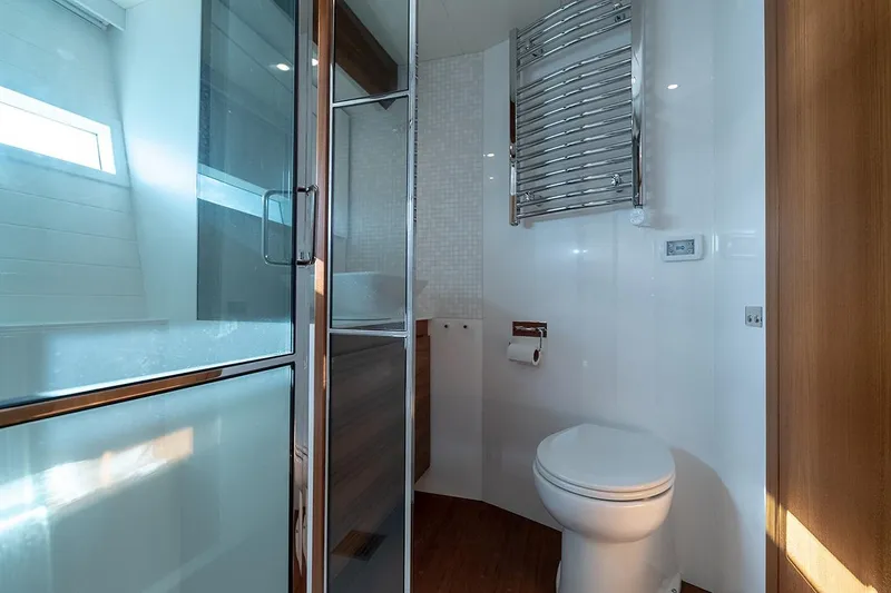 Freya Yacht Photos Pics Modern bathroom on 2023 Delta Powerboats 54 IPS, featuring sleek design and glass shower.